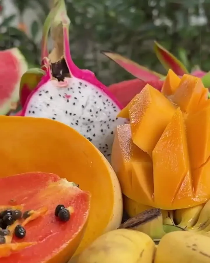 Fresh papaya, dragon fruit, mango and oranges